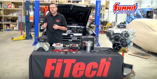 man at fitech booth in garage