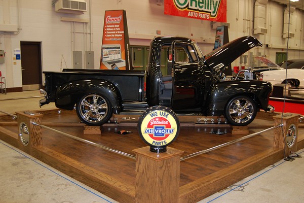 customized chevy 3100 pickup truck displayed at indoor car show