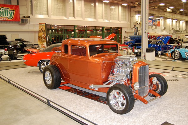 ford five window hot rod with supercharged engine at indoor car show
