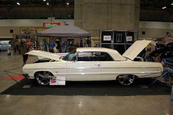 lowered chevy impala coupe at indoor car show