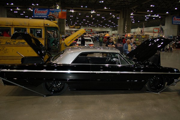 lowered chevy impala coupe at indoor car show