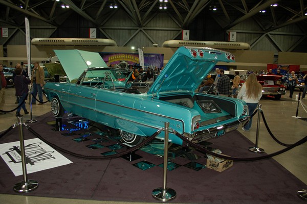 chevy impala convertible on display at indoor car show