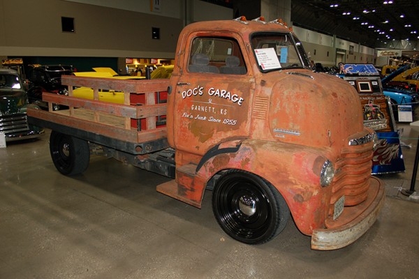 vintage coe chevy stake bed truck at indoor car show