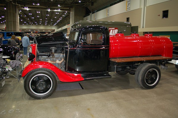vintage tanker truck on display at indoor car show