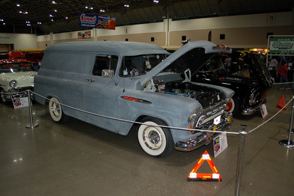 primered chevy panel wagon sedan at indoor car show
