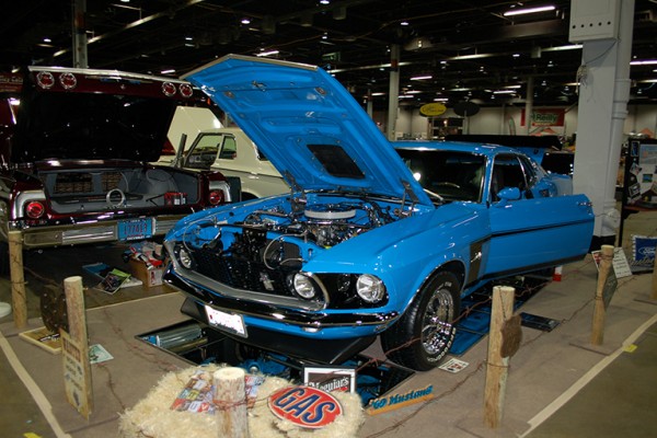 blue 1969 ford mustang at a car show