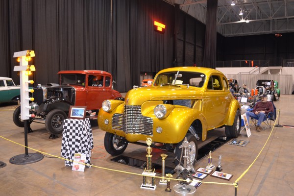 pair of gasser hot rods at indoor car show