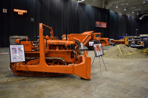 old tractors and earth movers on display at indoor car show