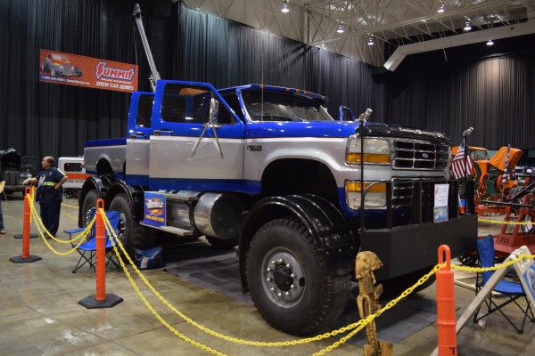 6 wheel, four door ford pickup truck on display at indoor car show