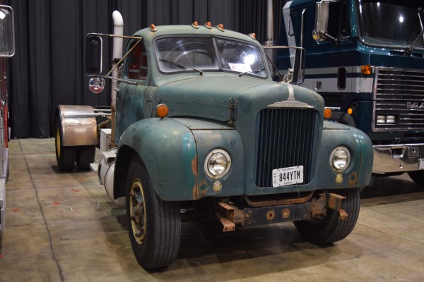 old semi truck on display at indoor car show