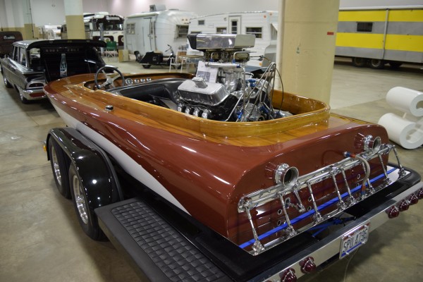 vintage speedboat on display at indoor car show