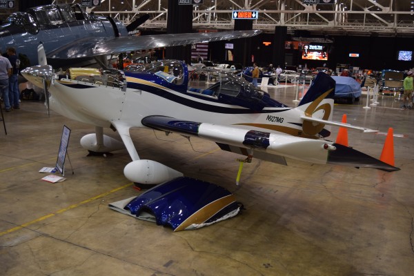 aircraft on display at indoor car show