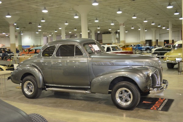 silver hot rod coupe at indoor car show