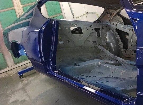 blue 1968 chevelle getting painted in body shop