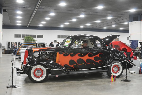 flamed hotrod coupe at indoor car show