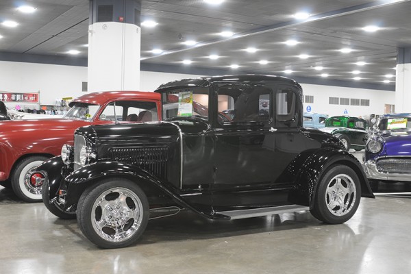 vintage ford five window coupe hot rod at indoor car show