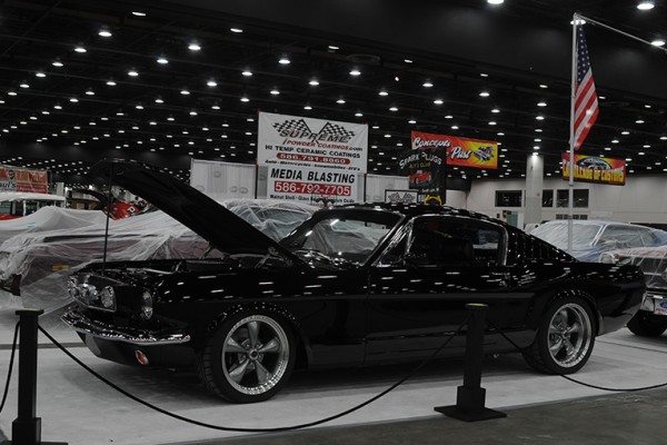 customized first gen ford mustang fastback coupe at indoor car show