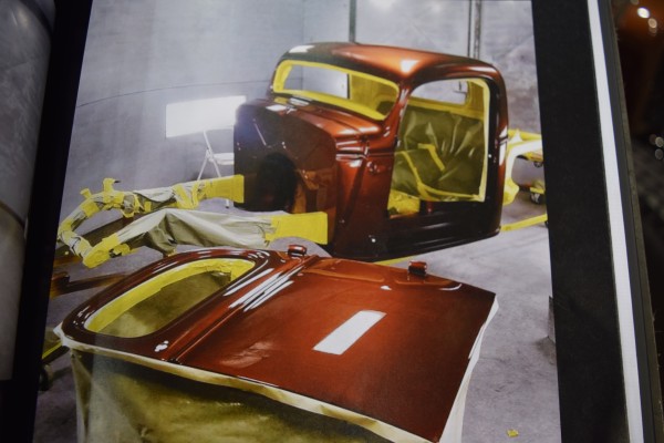 a hot rod in a paint spray booth