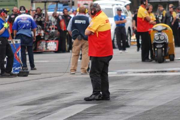 crew chief walking at starting line of drag race