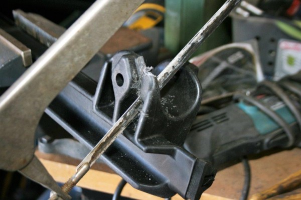 modifying a jeep soft top clip with a hacksaw