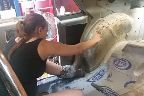 woman installing heat and sound insulation in an AMC AMX