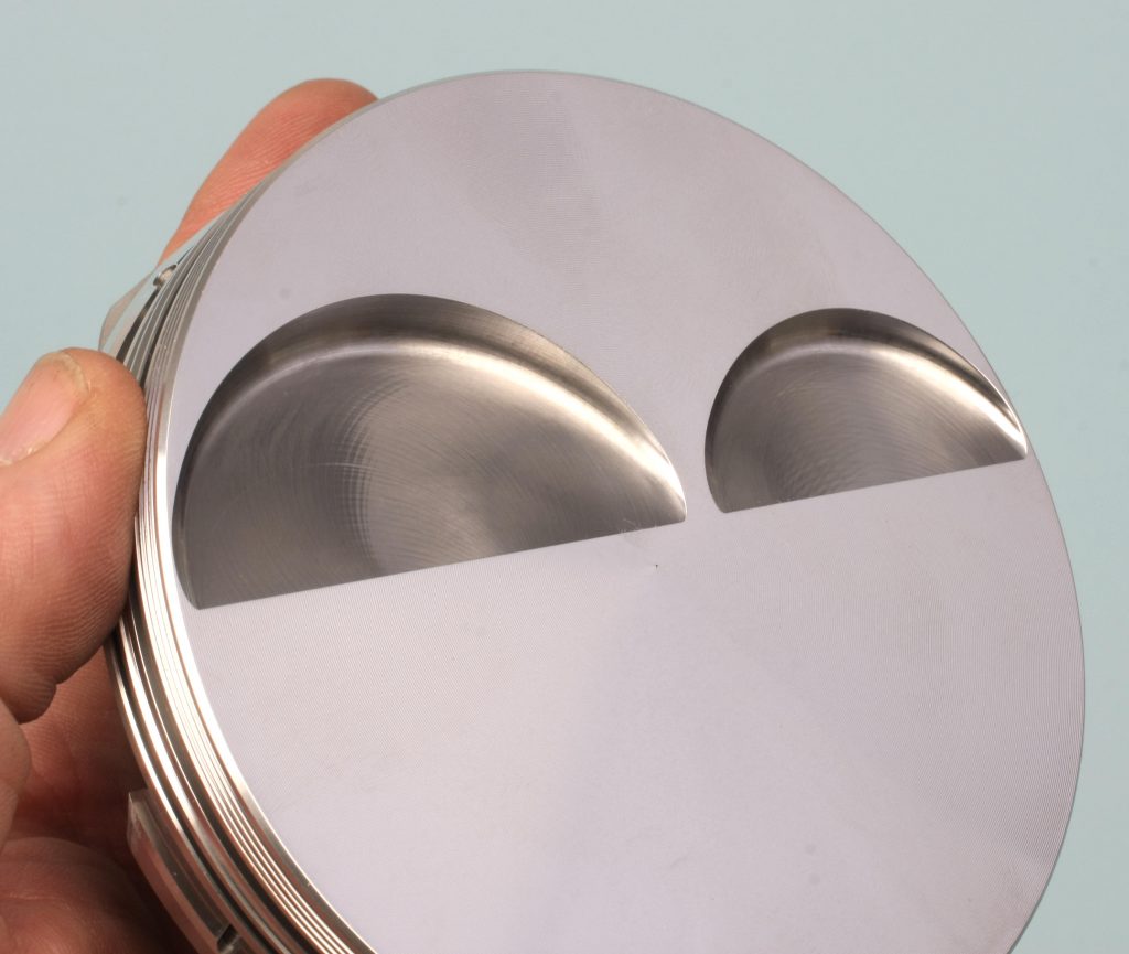 valve reliefs in a piston head face