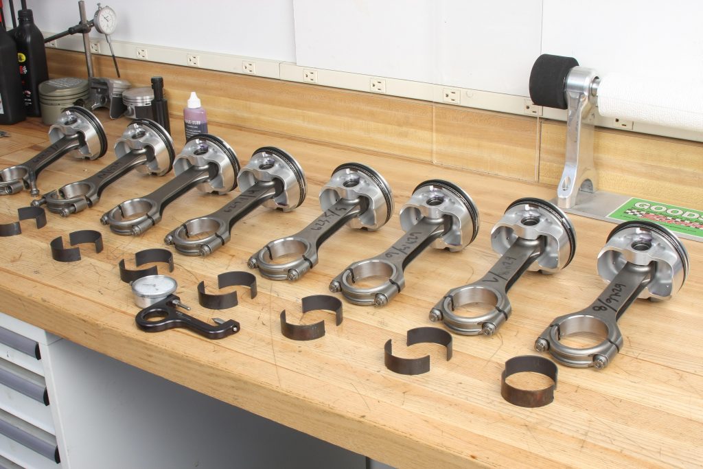 piston and rod assemblies on workbench awaiting install