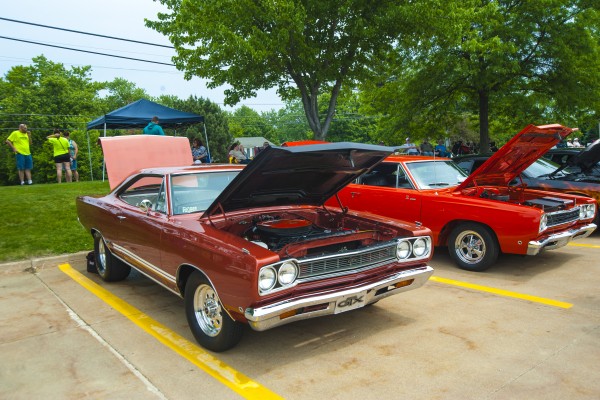 plymouth gtx and other classic mopar muscle cars at a car show