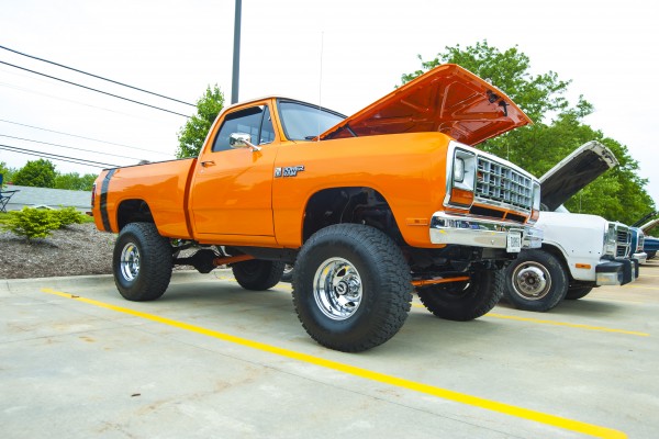 lifted dodge power ram truck at a classic car show