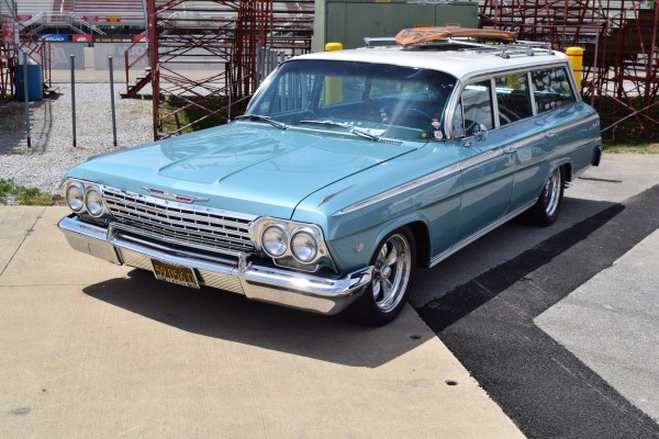 vintage chevy impala wagon with surf board on roof