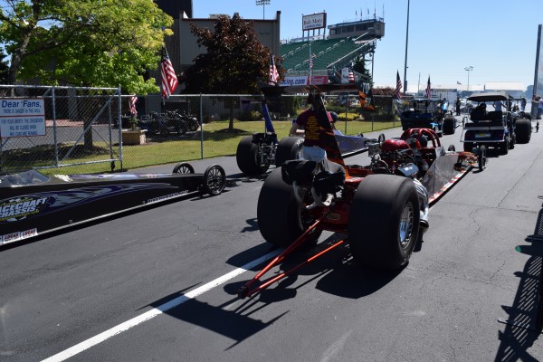 dragsters being towed to starting line at nhra event