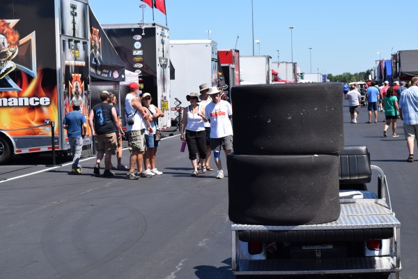 stack of tires being towed to nhra pit area