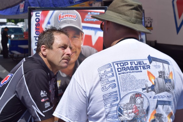 greg anderson talking with fans at nhra event