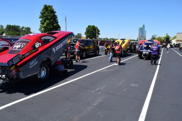 line of nhra top fuel cars in staging lanes