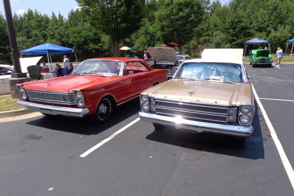 pair of ford galaxie coupes at a car show