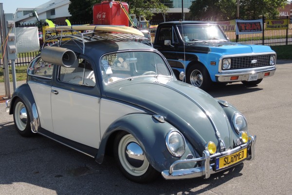 vintage vw beetle with surf board and luggage rack