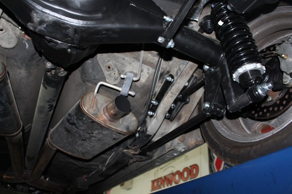 underside of a car with muffler and rear suspension