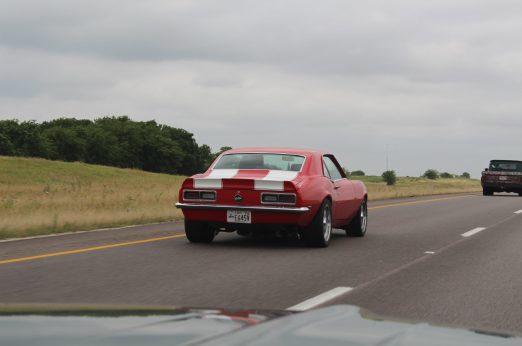 red and white camaro driving on highway