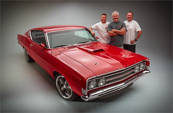group of men near a 1969 ford torino gt