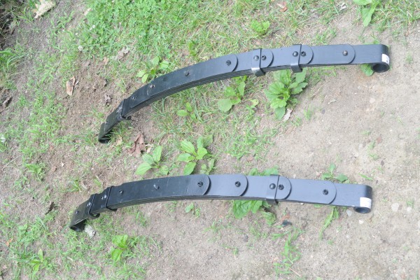 a pair of leaf springs laying on ground