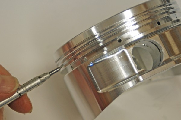 man pointing to a ring land on a piston head