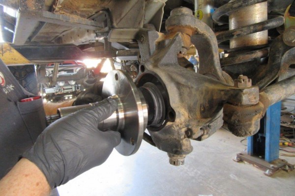 removing wheel hub assembly from an axle