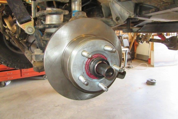 a new brake rotor on an axle assembly