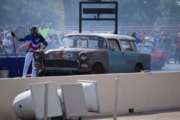 a vintage 18955 chevy nomad station wagon launching at a dragstrip