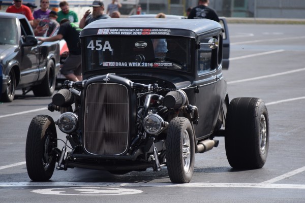 twin turbocharged ford hotrod coupe in staging lanes at dragstrip
