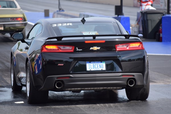 rear view of a late model camaro staging at a drag strip