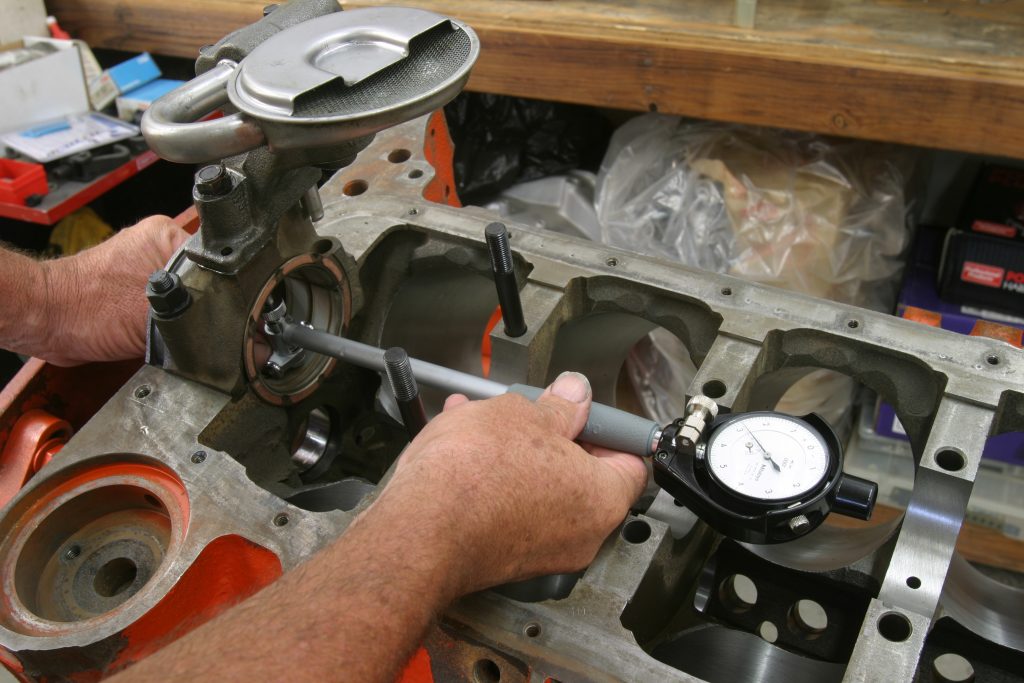 man checking main bearings with dial gauge