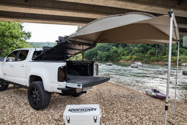 awning deployed with truck bed tonneau cover under bridge