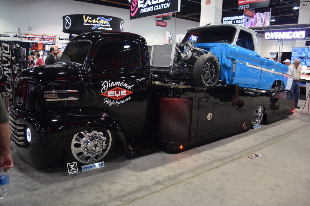 flatbed ford ramp autocarrier with hotrod truck on display at SEMA 2016