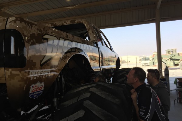 drivers inspecting bigfoot monster truck prior to show